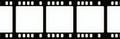 Blank filmstrip border with perforations shows multiple empty frames for adding content. This retro cinema element can be used Royalty Free Stock Photo