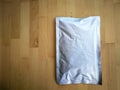 Blank Foil plastic pouch bag on wooden background. Royalty Free Stock Photo