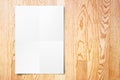 Blank folded paper poster hanging on wooden wall,Template mock u