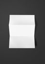 Blank folded White A4 paper sheet mockup template on black background Royalty Free Stock Photo