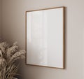 blank frame on beige wall mock up, vertical wooden poster frame on wall, mock up for picture or photo frame, empty frame on bright Royalty Free Stock Photo