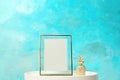 Blank frame and decorative pineapple figure on table