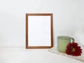 Blank frame mockup, ceramic cup with red flower  on white Royalty Free Stock Photo