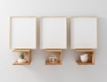 Blank frame mockup hang on wooden floating shelf Royalty Free Stock Photo