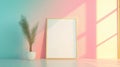 Blank frame on a pastel wall behind a compact workspace Royalty Free Stock Photo
