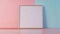 Blank frame on a pastel wall behind a compact workspace Royalty Free Stock Photo
