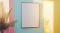 Blank frame on a pastel wall behind a compact workspace Royalty Free Stock Photo