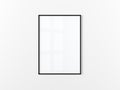 Blank frame. Poster mockup. Vertical frame hanging on a white wall. Isolated. Black.