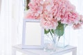 Blank frame on the table and flower decoration