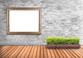 Blank frame vintage on a concrete wall with tree pot on wood flo Royalty Free Stock Photo