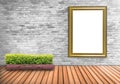 Blank frame vintage on a concrete wall with tree pot on wood flo Royalty Free Stock Photo