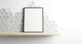 Blank framed picture on a wooden shelf against a hexagonal tile wall Royalty Free Stock Photo