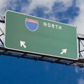 Blank freeway sign in blue cloudy sky