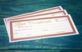 Blank Gift Certificates on a Wooden Table