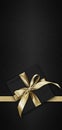 Blank gift greeting card with gift box present and bright shiny golden ribbon bow tape isolated on black background, top view and Royalty Free Stock Photo