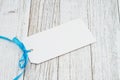 Blank gift tag with a blue ribbon Royalty Free Stock Photo