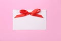 Blank gift tag with satin ribbon on color background Royalty Free Stock Photo