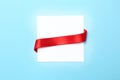 Blank gift tag with satin ribbon on color background Royalty Free Stock Photo