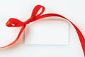 Blank gift tag tied with a bow of red satin ribbon Royalty Free Stock Photo