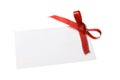 Blank gift tag tied with a bow of red satin ribbon. Isolated on white, with soft shadow Royalty Free Stock Photo