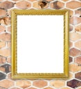 Blank golden frame on brick hexagonal stone wall Royalty Free Stock Photo