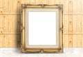 Blank Golden Vintage frame on marble floor and plank wooden wall Royalty Free Stock Photo