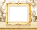 Blank golden vintage photo frame with sparkling gold bokeh wall