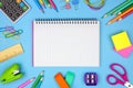 Blank graphing paper notebook with school supplies frame against blue. Back to school. Copy space. Royalty Free Stock Photo