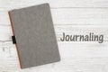 Blank gray journal on a weathered whitewash wood background