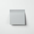 A blank, gray square sheet of paper is placed on a white surface. It casts a subtle Royalty Free Stock Photo