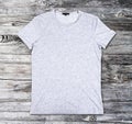 Blank gray t-shirt on a wooden surface