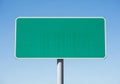 Blank green road sign against a clear blue sky for text or graphics Royalty Free Stock Photo
