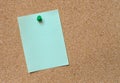 Blank green note pinned on cork board Royalty Free Stock Photo