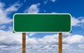 Blank Green Road Sign with Wooden Posts Over Blue Sky and Clouds Royalty Free Stock Photo