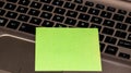 Blank green sticky note, post it on keyboard. Close up Royalty Free Stock Photo