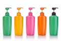 Blank green, yellow, pink and orange plastic pump bottle used for shampoo or soap. Studio shot isolated on white Royalty Free Stock Photo