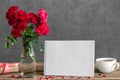 Blank greeting card with bouquet of rose flowers, cup of tea and gift box. wedding background Royalty Free Stock Photo
