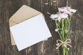 Blank greeting card with brown envelope and Mum flowers on wooden table Royalty Free Stock Photo