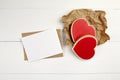 Blank greeting card mockup with paper envelope and red heart on white wooden table Royalty Free Stock Photo