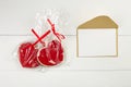 Blank greeting card mockup with paper envelope and red heart on white wooden table Royalty Free Stock Photo