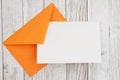 Blank greeting card with orange envelope on wood Royalty Free Stock Photo