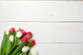 Blank greeting card with tulips flowers on white wooden table. Romantic wedding card, greeting card for womans or mothers day, bir Royalty Free Stock Photo