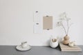 Blank greeting cards mockups mockups taped on white wall.Vase with dry lunaria, honesty plant and white pumpkins. Office