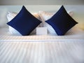 Blank greetings card at the Dark Blue Pillow on the bed with Hotel turn down