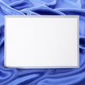 Blank greetings card or invitation with blue satin background