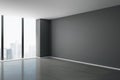 Blank grey mock up wall in modern spacious hall with concrete floor, big window and city view Royalty Free Stock Photo