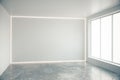 Blank grey wall in empty room with big windows and concrete floor Royalty Free Stock Photo