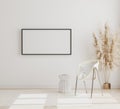 Blank horizontal picture frame mock up on white wall in modern interior background with chair and pampas grass on wooden floor, Royalty Free Stock Photo