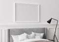 Blank horizontal picture frame on white wall in bedroom. Mock up poster frame in modern interior. Free space, copy space Royalty Free Stock Photo