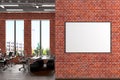 Blank horizontal poster mock up on the red brick wall in office interior. Royalty Free Stock Photo